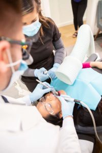 Patient having her amalgam fillings removed.