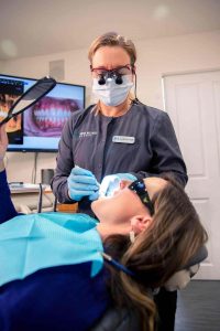 dental hygienist, Christine, doing a preventive service on a patient